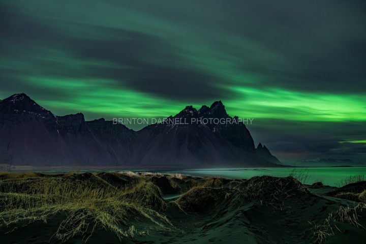 Aurora-behind-the-clouds-at-Stokksnes